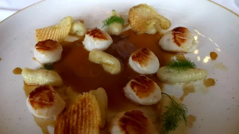 Close up fennel gnocchi with cod fish morsels sauce. Homemade pasta. Panning 4K Stock Footage 297752701