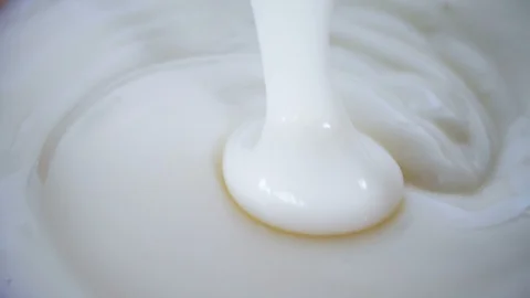 Close up fermented milk probiotic yogurt , healthy food , mixing cream curd Stock Footage 117660251