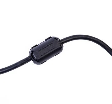 Close up of a ferrite bead inductor on cable on isolated white Stock Photos