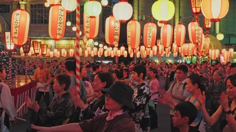 Close Up of Festival Goers Clapping Beneath a Dense Lantern Canopy Stock Footage 345816507