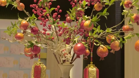 Close-up of a festive arrangement includes artificial pomegranates, red berries Stock Footage 340630968