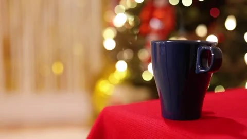 A Close Up Of A Festive Blue Mug with Steam on Holiday Table Stock Footage 313858048
