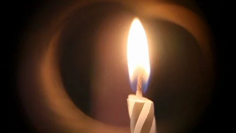 A close-up of the festive candle flame, beautiful reflections around the fire Stock Footage 116373638