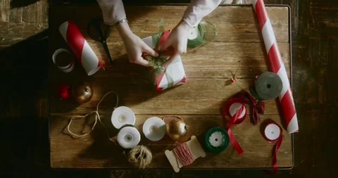 Close-up festive footage of a person adding decorative Christmas elements Stock Footage 321426776