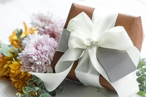 Close up of festive gift box and chrysanthemum flowers. Stock Photos