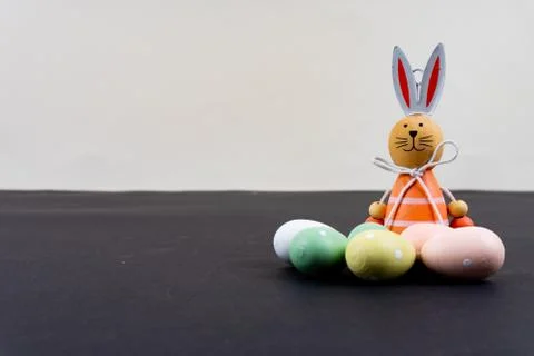 Close up of a few colorful easter eggs and a easter bunny on black background Stock Photos