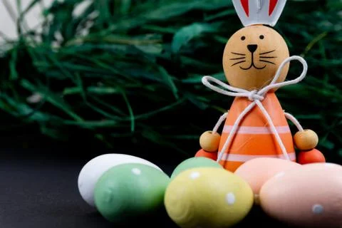 Close up of a few colorful easter eggs, a easter bunny and easter grass on bl Stock Photos