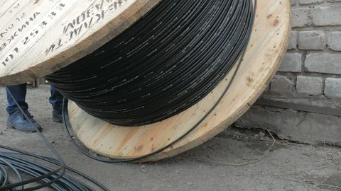 Close-up. fiber optic cable on a large wooden spool. Stock Footage 126996214