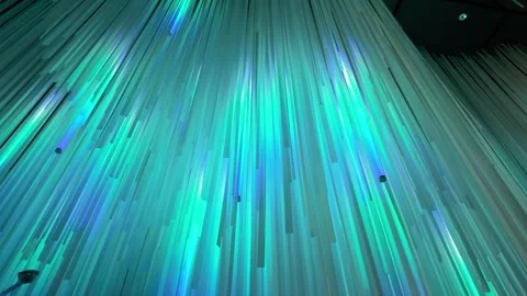 Close-up of fiber optic strands, thin, translucent lines cascading downward 動画素材 327573573