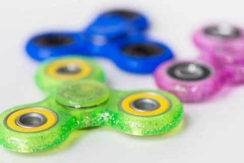 Close up of fidget spinners on white background Stock Photos