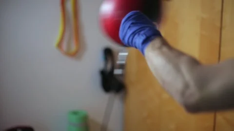 Close-up fighter's hands in boxing wraps punching double end striking bag. Stock Footage 104879313