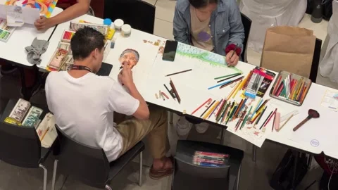 Close up of Filipino artists at work during a Nationwide, 'Sketchfest' event. Stock Footage 286792677
