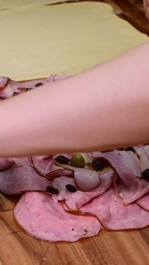 Close-up of Filling and Rolling Ham Bread Dough for Baking Stock Footage 332567592