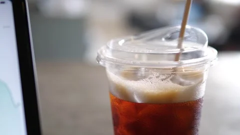 Close-up of financial candlestick chart on tablet screen with iced coffee Video stock 332359684