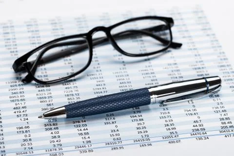 Close-up Of A Financial Data Sheet With Eyeglasses And Ballpen Stock Photos