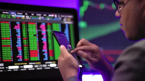 Close-up financial using smartphone analyze exchange rate diagram. Investor. Stock Footage 185353182