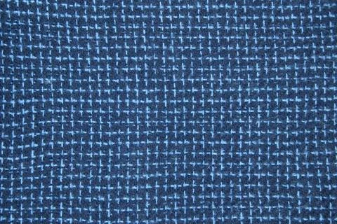 Close-up of fine-checked woolen texture in blue. Machine knitted woolen goods Stock Photos