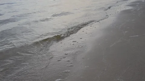 Close up of fine sand texture on a calm river beach with water reflection Stock Footage 336636978