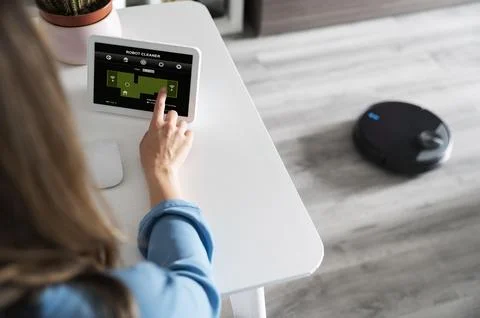 Close up finger activating robot cleaner Stock Photos