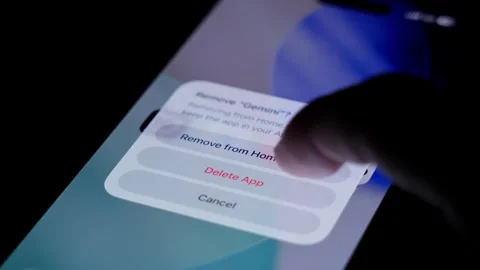 Close up of finger deleting Gemini icon on smartphone screen, showing modern Stock Footage 334062977
