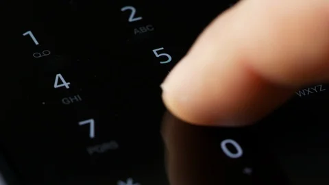 Close up finger dialing pin or phone number on digital keyboard screen Stock Footage 123545266