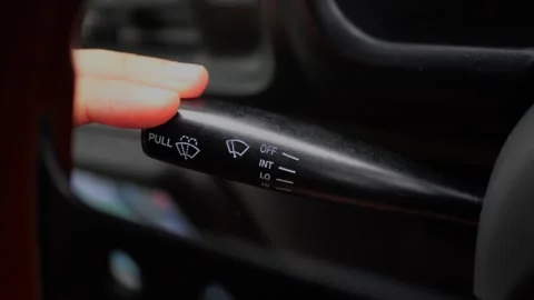 Close-up of finger operating the windshield wiper control... Stock Footage 339101343