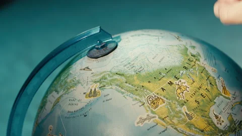 Close up of finger pointing on globe Видео 172624027