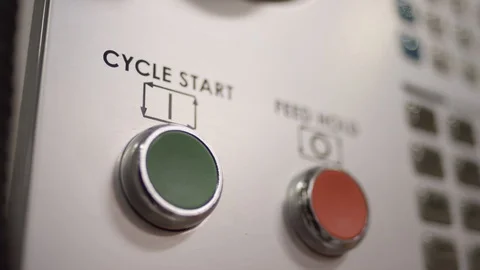 Close up finger press start button on mold machine in manufacturing plant Stock Footage 129987614