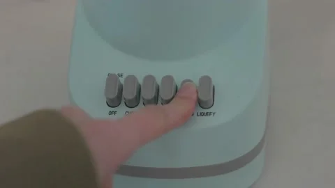 Close up finger presses blender button Stock Footage 235857681