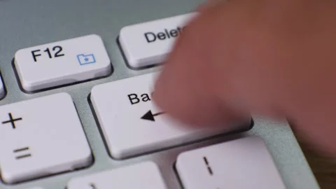Close-up of finger pressing backspace key on keyboard Stock Footage 345486228