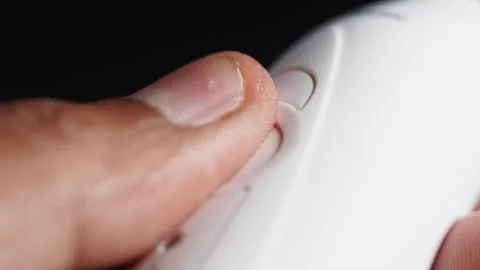 Close-up of finger pressing a button on electric tooth brush Stock Footage 322147186