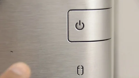 Close up of finger pressing ON-OFF button with hard disc icon Vidéo 70660824