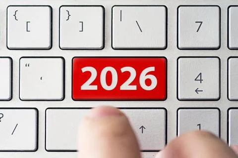 Close-up of a finger pressing a button labeled 2026, symbolizing the start of Stock Photos