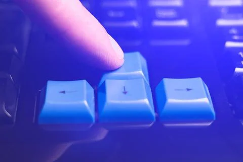 Close-up of finger is pressing computer keys on keyboard during work. Singl.. Stock Photos