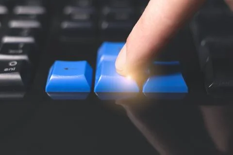 Close-up of finger is pressing computer keys on keyboard during work. Singl.. Stock Photos