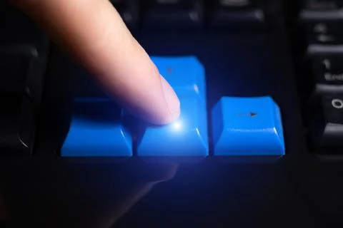 Close-up of finger is pressing computer keys on keyboard during work. Singl.. Stock Photos