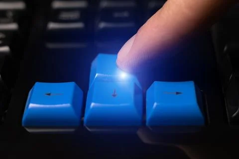 Close-up of finger is pressing computer keys on keyboard during work. Singl.. Stock Photos