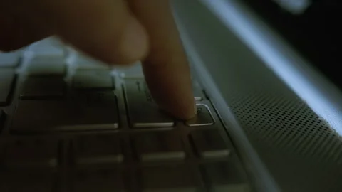 Close-up of a Finger Pressing the Delete Key on a Laptop Keyboard in Low Ligh Stock Footage 303913963