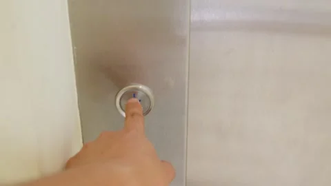 Close up finger pressing elevator button to go down in a modern apartment Stock Footage 306005543