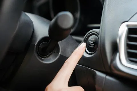 Close up of finger pressing engine start button until engine turns on. Foto stock