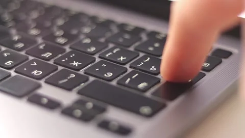 Close-Up Finger Pressing Enter Key on Laptop Keyboard Stock Footage 325036219