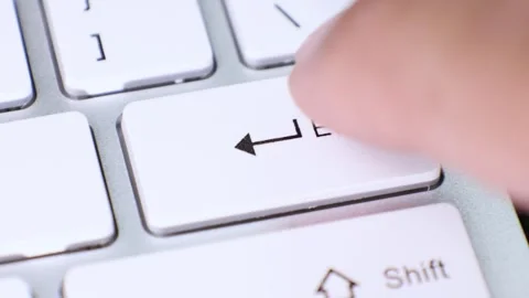 Close-up of finger pressing enter key on keyboard Stock Footage 337536804