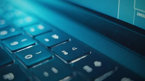 Close up on finger pressing Mute key with small illuminated icon on laptop Stock Footage 340234145
