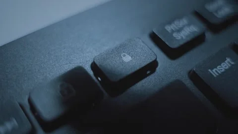 Close up on finger pressing padlock button or key on computer keyboard 库存影片 331216108