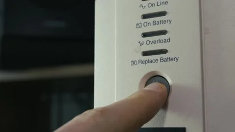 Close Up of Finger Pressing Power Button on UPS Battery Backup Stock Footage 328152668