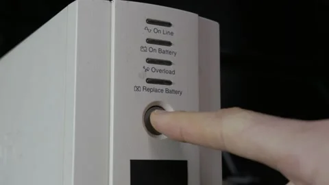 Close Up Finger Pressing Power Button on White UPS Backup System Stock Footage 328152675