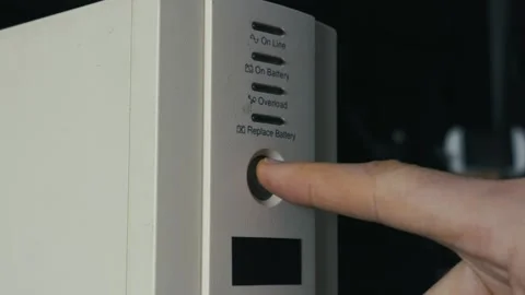 Close Up Finger Pressing Power Button On UPS Battery Backup Device Stock Footage 329487566