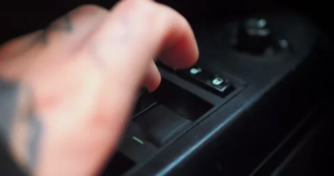 Close-up of a finger pressing the power window switch inside... Stock Footage 319882512