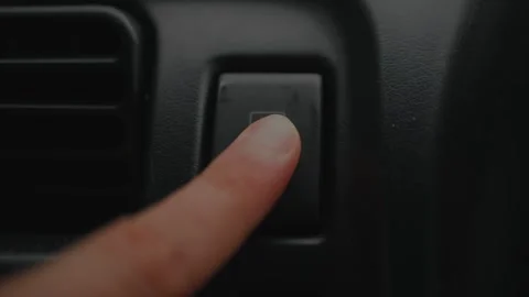 Close-up of finger pressing the rear window defroster... 스톡 동영상 339101329