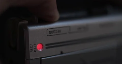 Close-Up Of Finger Pressing Record Button Of Microcassette Recorder And Video stock 188427197